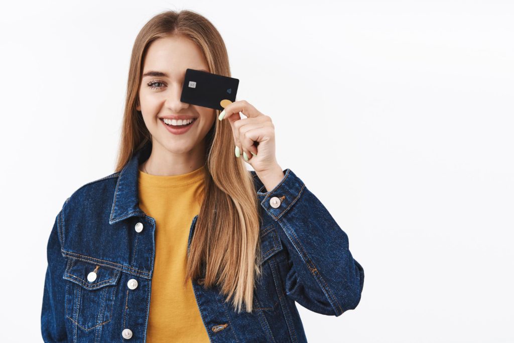 A woman holding a Aeroplan Credit Card.