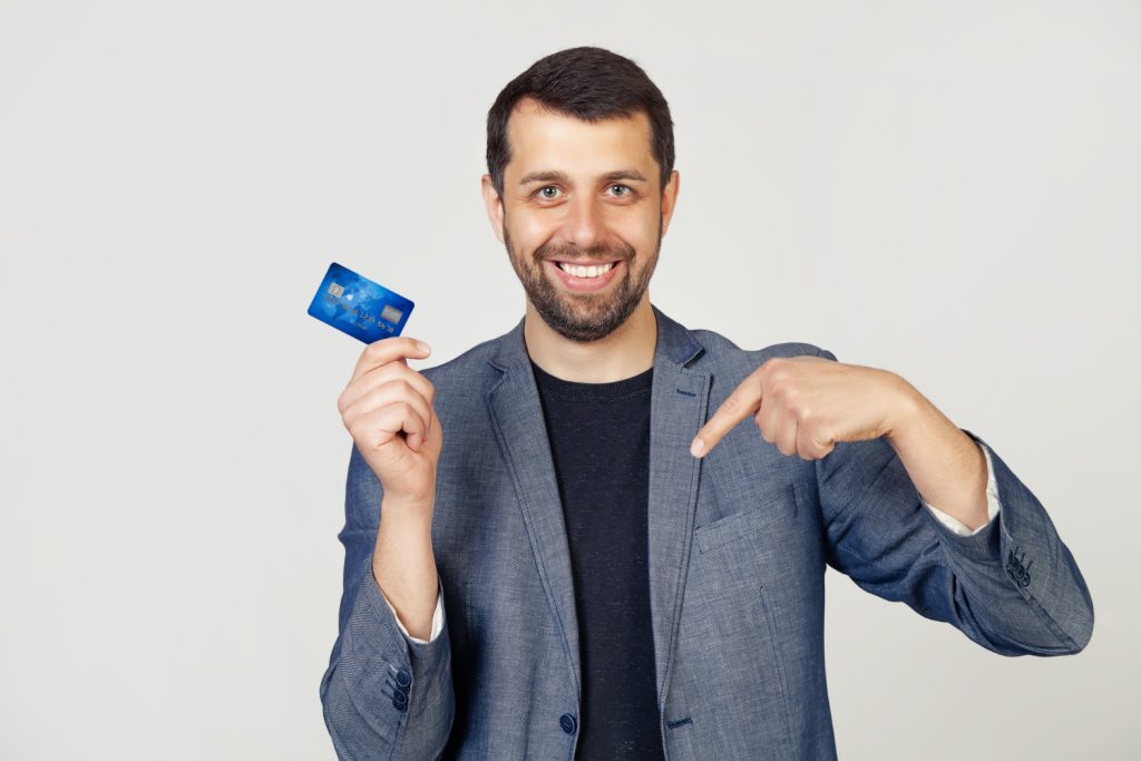 A man holding his Bank of America Travel Rewards.