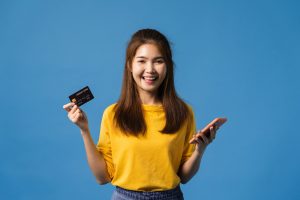 A girl holding a Bilt Mastercard.