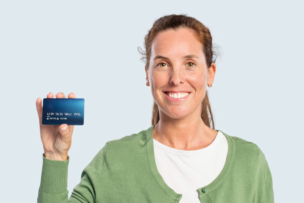 A woman holding a Chase Freedom Unlimited.