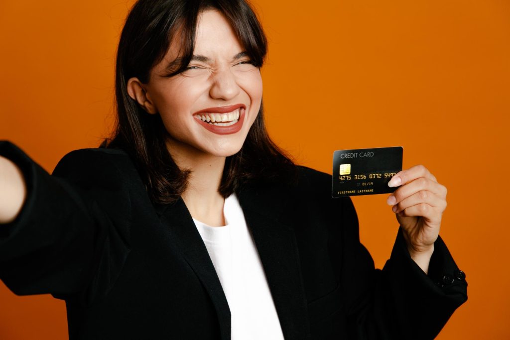 Woman holding Citi Diamond Preferred Card.