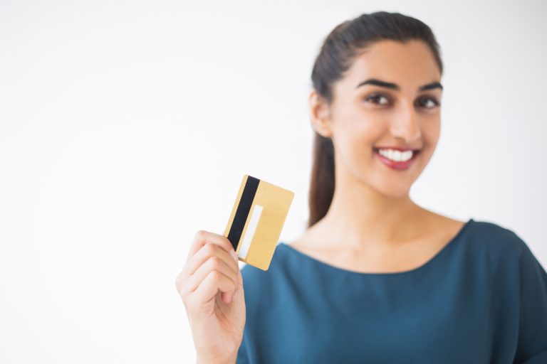 Woman holding her Delta SkyMiles Gold credit card