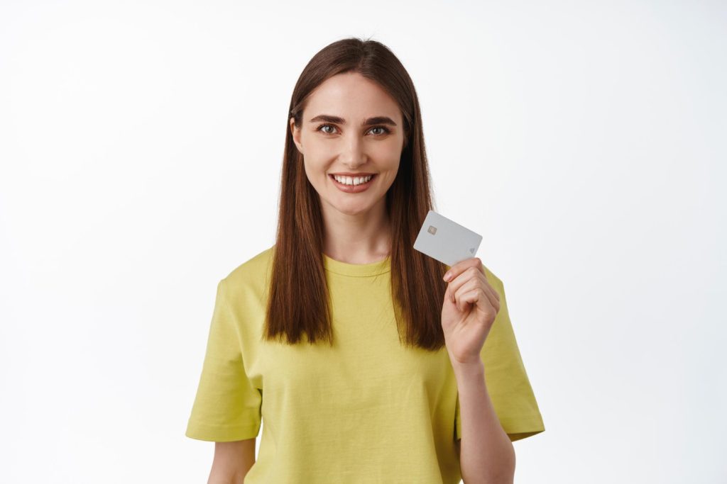 Woman holding her Discover it Secured Credit Card.