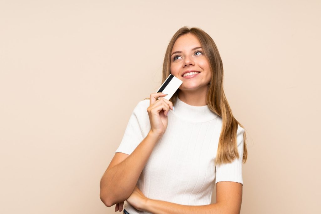 Woman holding her Hilton Honors American Express.