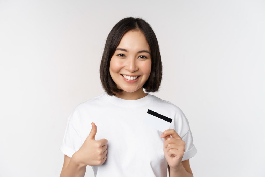 Woman holding her Mission Lane Visa Card.