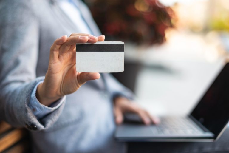 Someone using the QuicksilverOne Capital One Card.