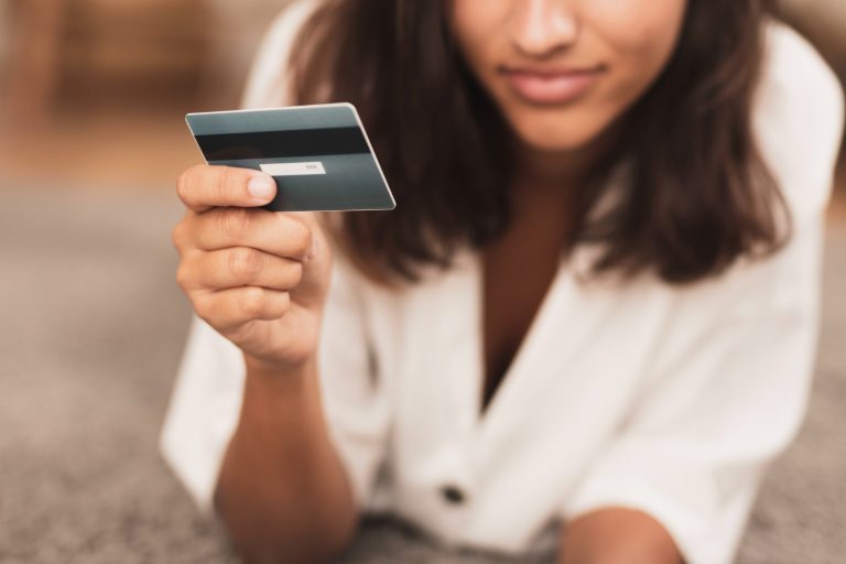 Woman holding her Simmons Visa.