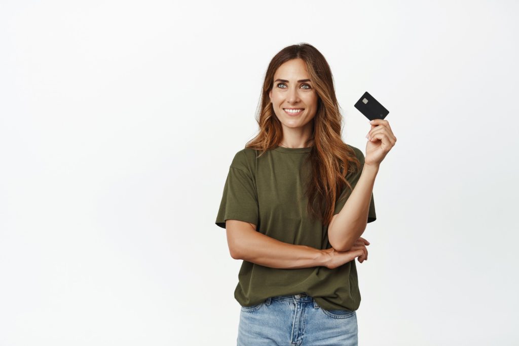 A woman holding her United Club Infinite Card.